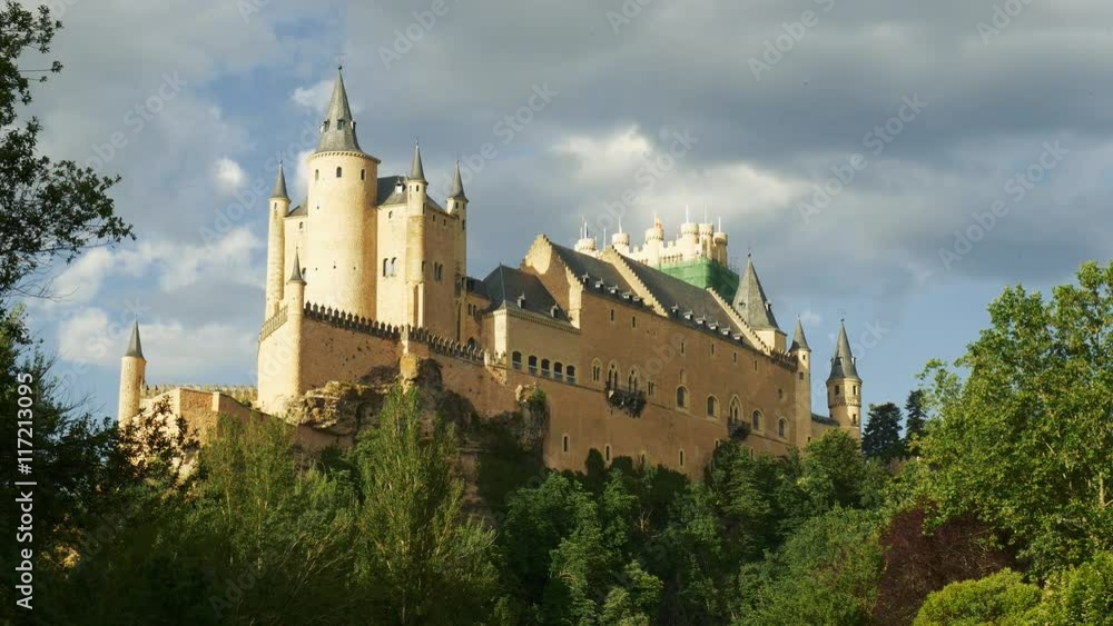 Middle age castle, romantic medieval fortress with perfect evening colored sunset light and beautiful clouds. The spanish castle Alcazar of Segovia, in Castilla y Leon, Spain Middle age castle, romantic medieval fortress with perfect evening colored sunset light and beautiful clouds. The spanish castle Alcazar of Segovia, in Castilla y Leon, Spain