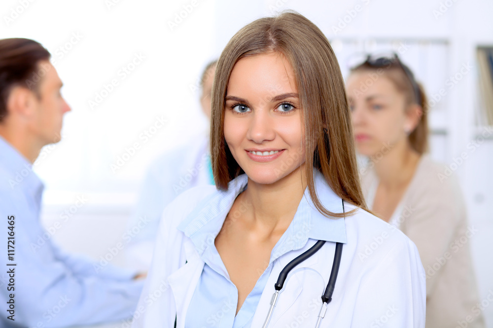 Happy doctor woman with medical staff at the hospital sitting at the table and discussing medical history Happy doctor woman with medical staff at the hospital sitting at the table and discussing medical history