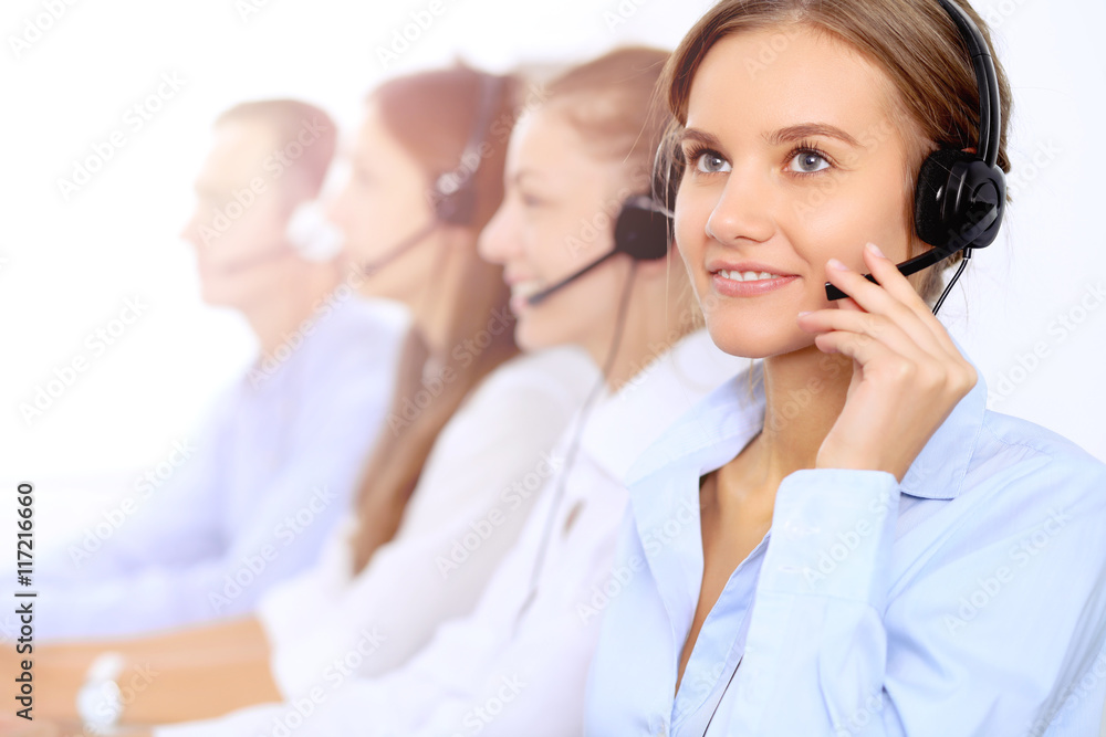 Young beautiful business woman in headset. Call center operator. Young beautiful business woman in headset. Call center operator.