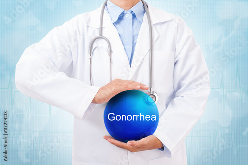 Obraz na plátně Doctor holding blue crystal ball with gonorrhea sign on medical background