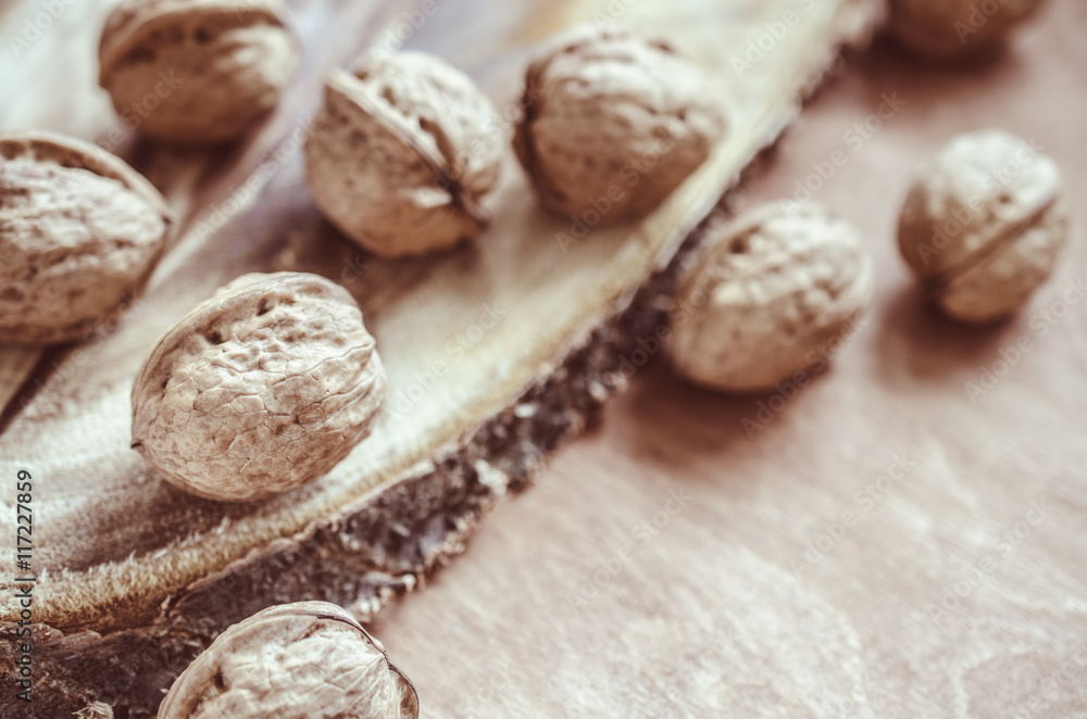Whole walnuts on rustic old wooden table. Whole walnuts on rustic old wooden table.