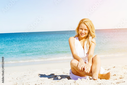 Young woman relaxing on the beach © Sergey Nivens