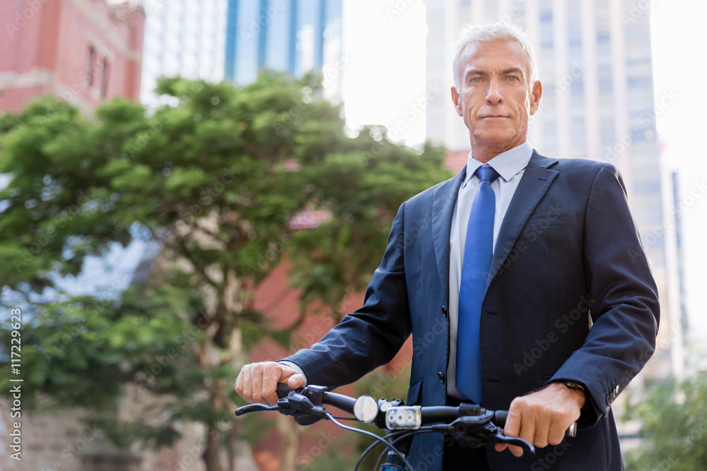Successful businessman riding bicycle Successful businessman riding bicycle