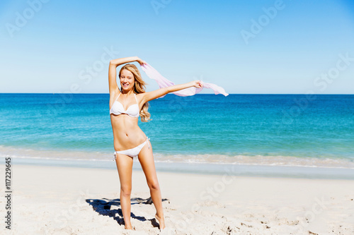 Fototapeta Naklejka Na Ścianę i Meble -  Young woman relaxing on the beach