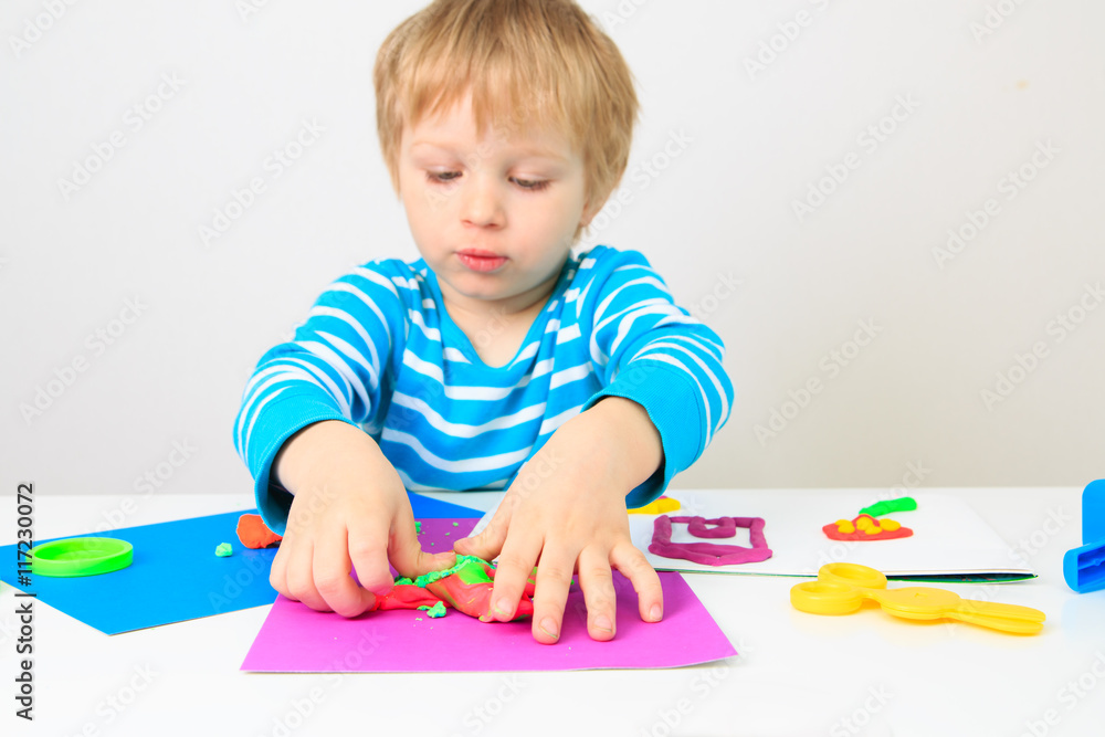 little boy playing with clay dough, education and daycare little boy playing with clay dough, education and daycare