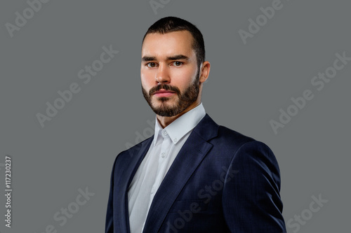 Portrait of bearded male in a suit.