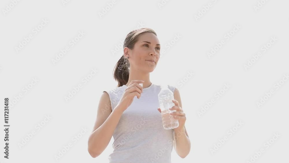 Jogger woman drinking water after exercising Jogger woman drinking water after exercising