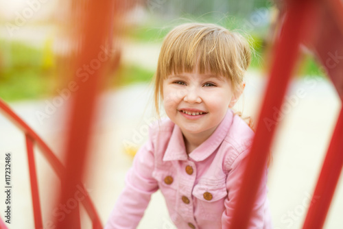 little beautiful smiling girl on playground outside