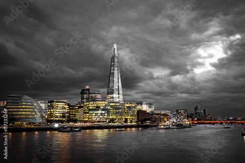 Black and white gloomy sunset over the skyline of London and the river Thames, England, UK