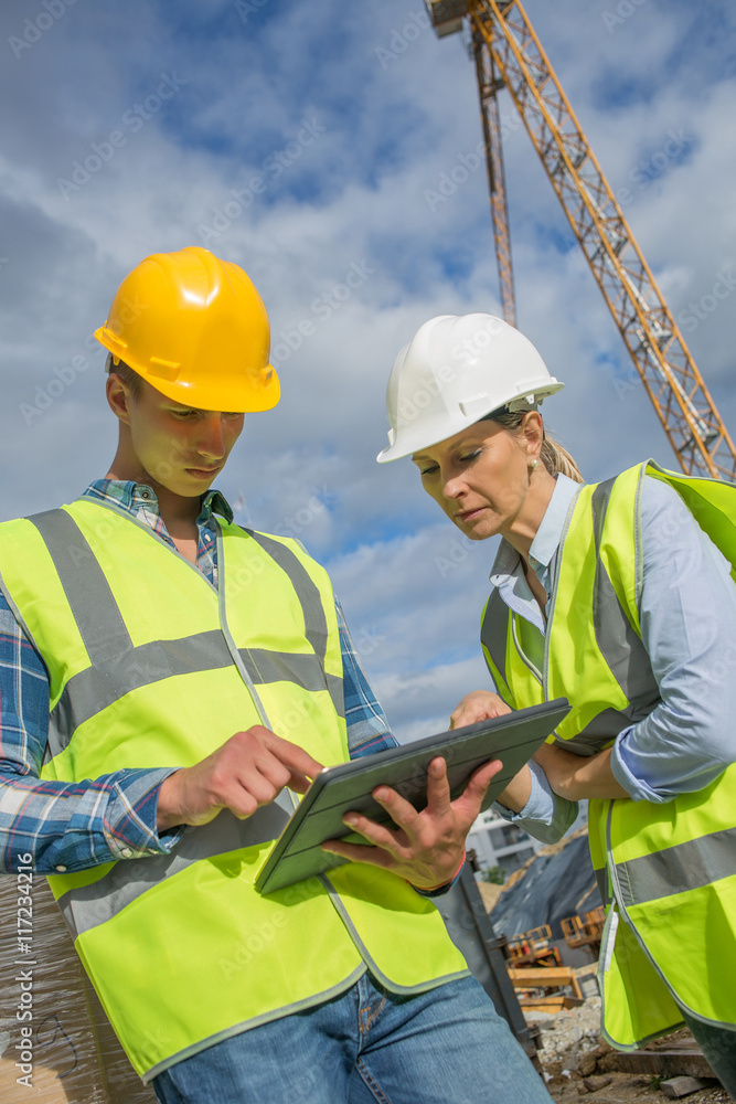 business, building, paperwork and people concept - builder in hardhat with tablett outdoors business, building, paperwork and people concept - builder in hardhat with tablett outdoors