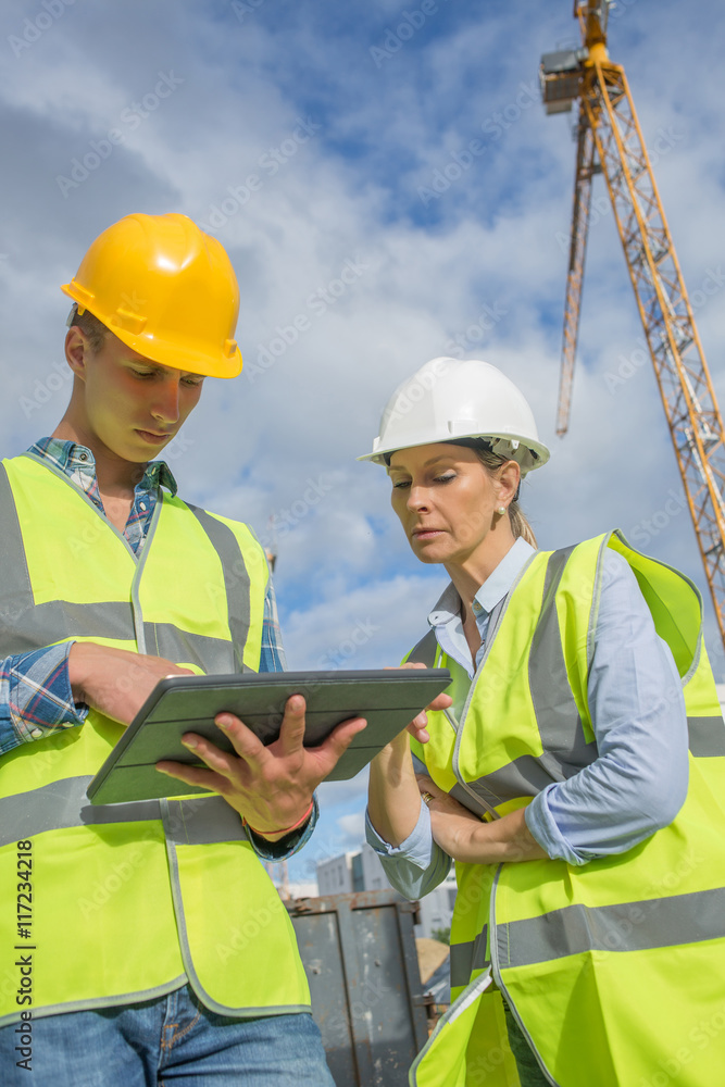 business, building, paperwork and people concept - builder in hardhat with tablett outdoors business, building, paperwork and people concept - builder in hardhat with tablett outdoors