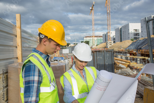View of a Engineer and worker checking plan on construction site