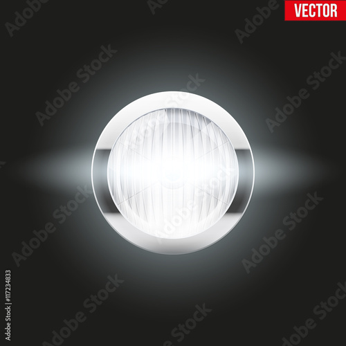 Round car headlight is on.