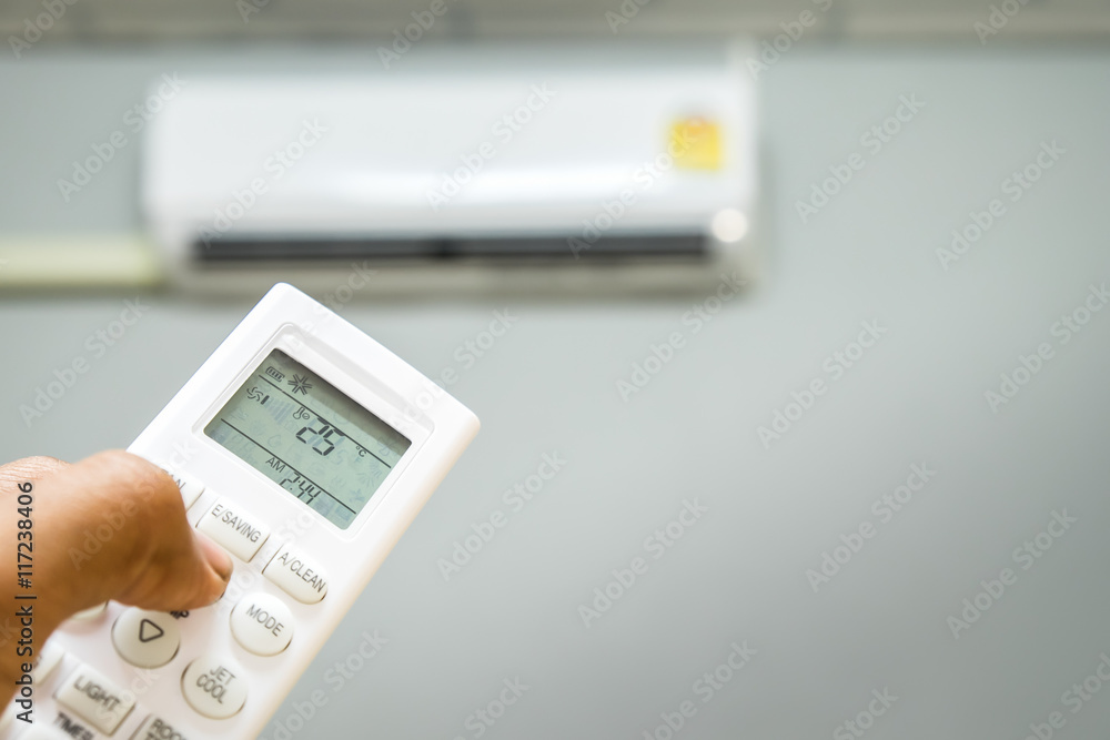 hand holding air conditioner remote hand holding air conditioner remote