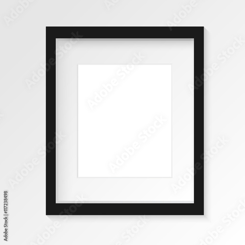 Black vertical photo frame on gray wall with realistic shadows. Vector illustration. EPS10.