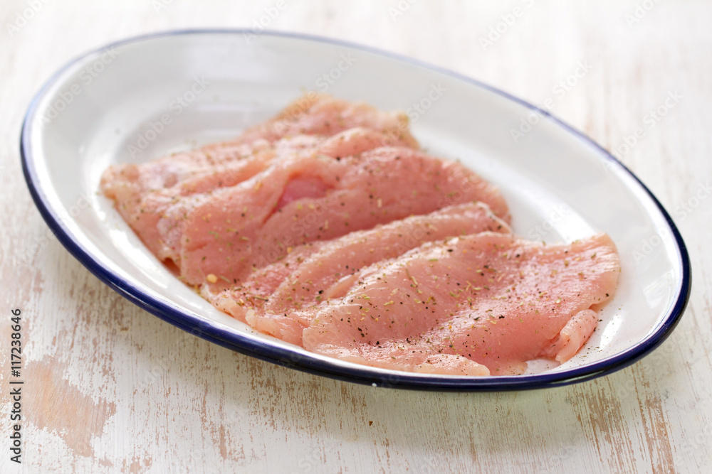 raw meat on white dish on white wooden background