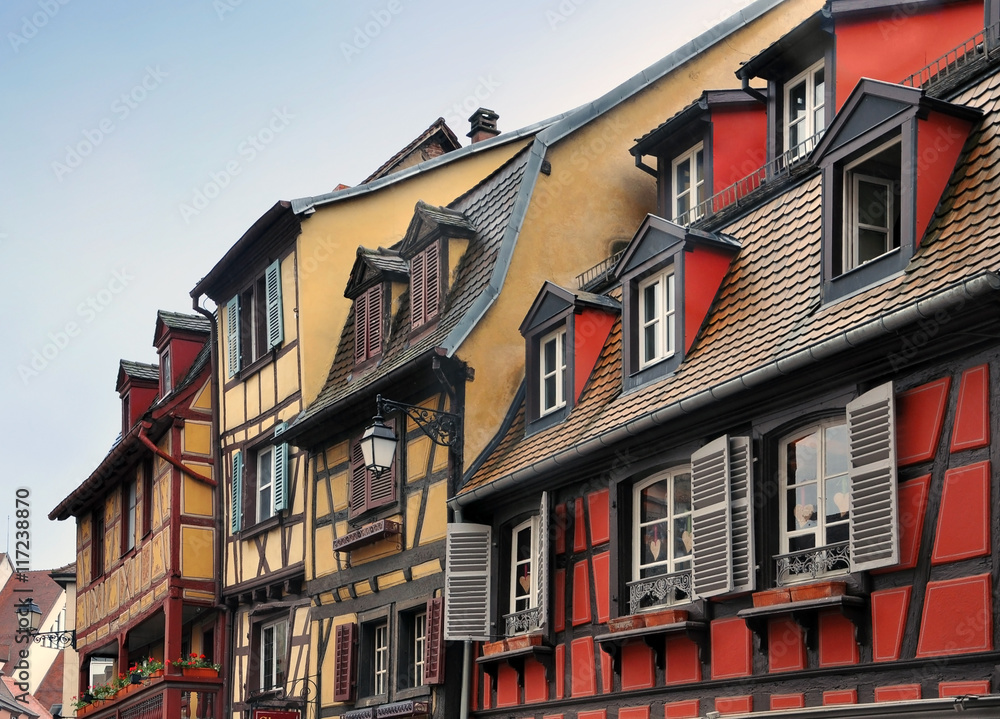 Pitched roof with skylight of old half-timbered houses of different colors. Colmar, Alsace, France.