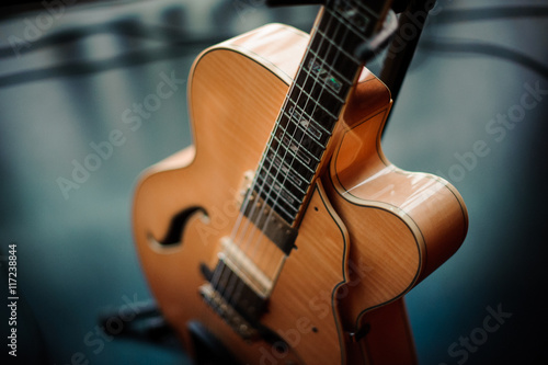 six-string acoustic guitar on a stand