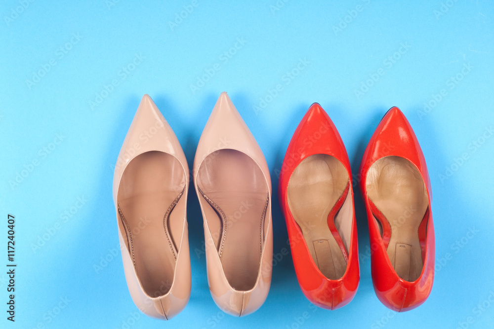 A picture of different shoes, Shot of several types of shoes, Several designs of women shoes. Leather Shoe. Pile of various female shoes on on light blue background. Copy space for text. A picture of different shoes, Shot of several types of shoes, Several designs of women shoes. Leather Shoe. Pile of various female shoes on on light blue background. Copy space for text.