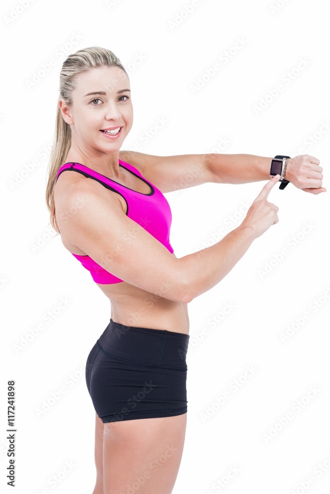Female athlete using her smart watch Female athlete using her smart watch