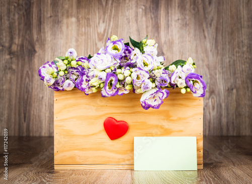 Fototapeta Naklejka Na Ścianę i Meble -  Fresh flowers in the box on wooden background