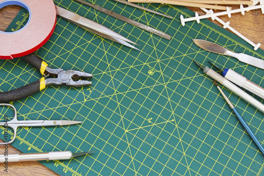 Plastic model kit and tools, hobby workplace background top view