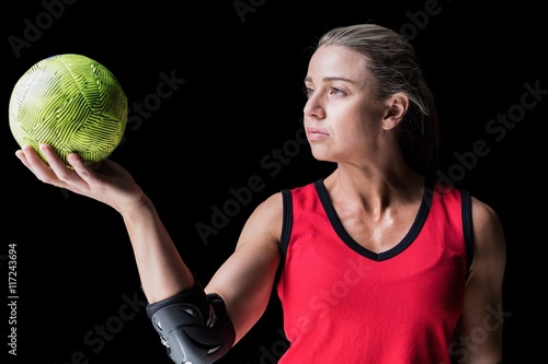Female athlete with elbow pad holding handball © WavebreakmediaMicro