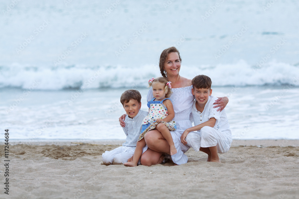 Portrait of cheerful, happy mother and sons on beach Portrait of cheerful, happy mother and sons on beach