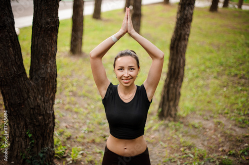 Practicing of yoga outdoors in forest