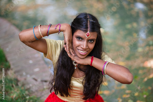 Portrait of a young beautiful cheerful traditional indian woman photo