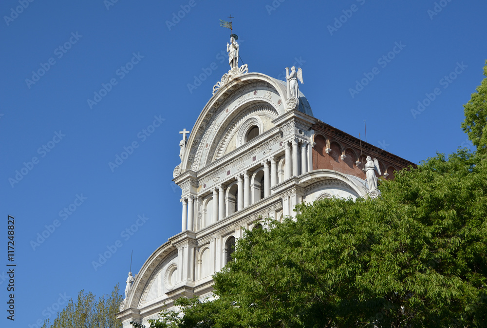 Obraz premium San Zaccaria renaissance facade rises above the trees, in Venice