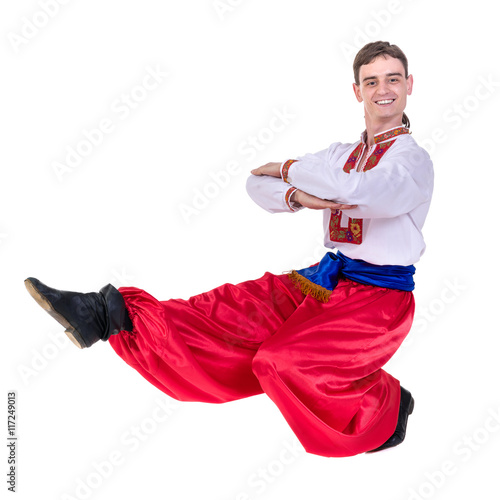 young man wearing a folk russian costume dancing against isolated white with copyspace