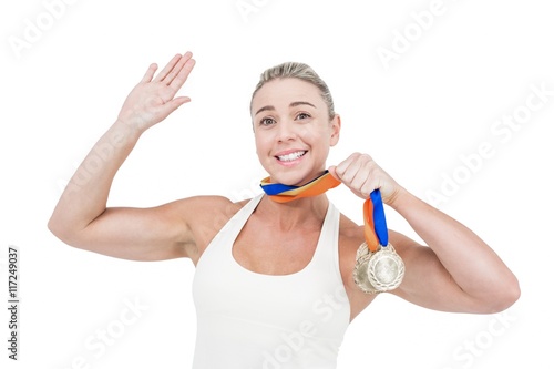 Happy female athlete holding medals