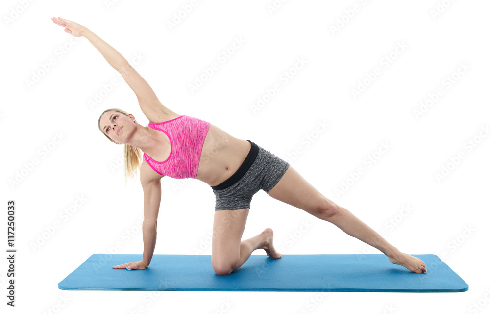 Young woman exercising on mat