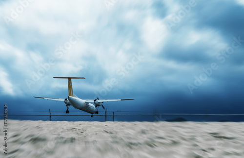 Fototapeta Naklejka Na Ścianę i Meble -  Landing airplane near the beach, business and travel concept