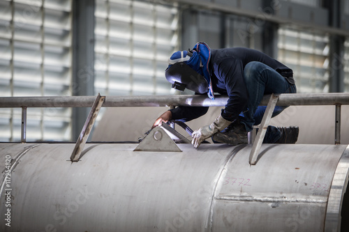 close up of technician welding metal pipe with argon,focus flash