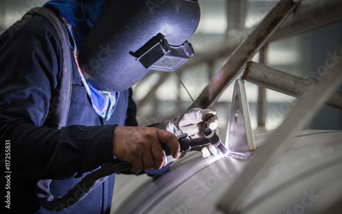 close up of technician welding metal pipe with argon,focus flash