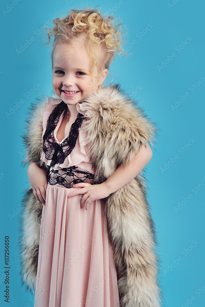 little girl in a long dress and a fur coat