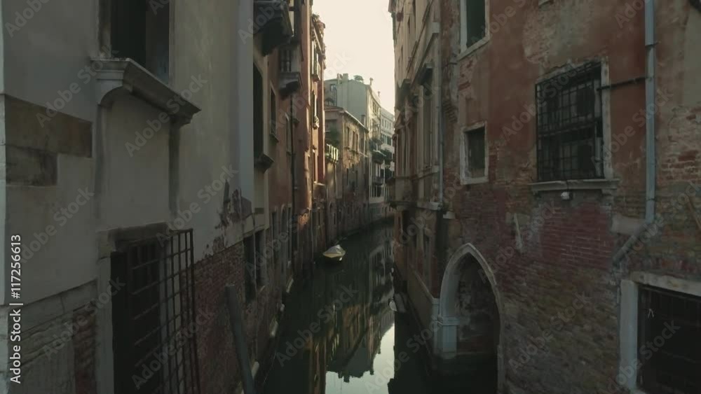 VENICE, ITALY - JUNE 19, 2016: Walking through the streets of Venice with small canals and ancient buildings views. Venice, Italy. VENICE, ITALY - JUNE 19, 2016: Walking through the streets of Venice with small canals and ancient buildings views. Venice, Italy.