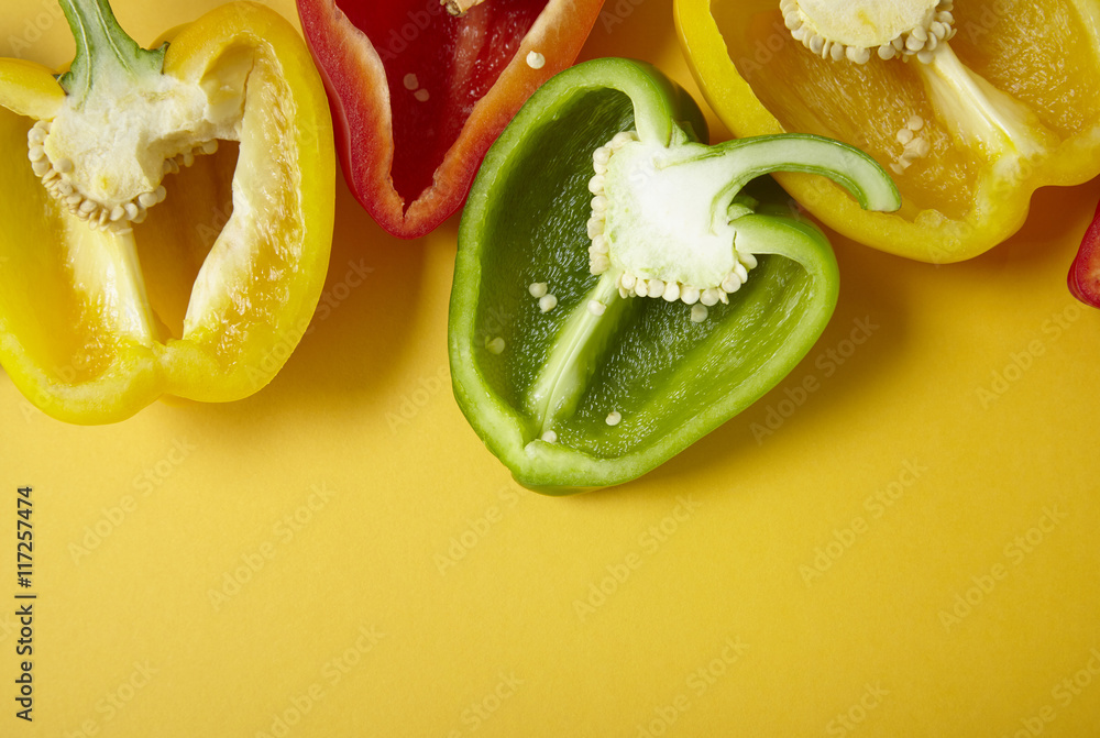 Sweet bell pepper halves on a yellow background forming a page header Sweet bell pepper halves on a yellow background forming a page header