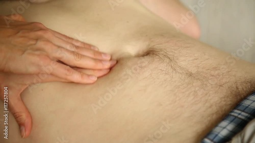 abdominal palpation examination in medical centre. doctor's hand on patient stomach