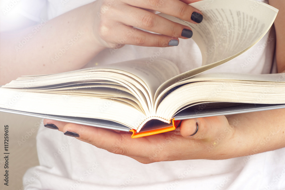 Fototapeta premium Young girl reading an open book old book. Knowledge, Science. To