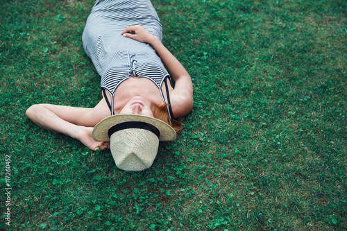 Trendy Hipster Girl Relaxing on the Grass photo