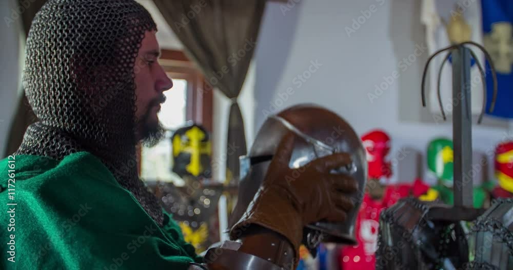Many knights are in a room and they are getting ready to go to a battle. They are taking spears and swords and armours. Wide-angle shot.
Many knights are in a room and they are getting ready to go to a battle. They are taking spears and swords and armours. Wide-angle shot.