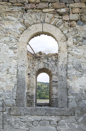 Old stone arc window in the window    ruin of church  Bulgaria