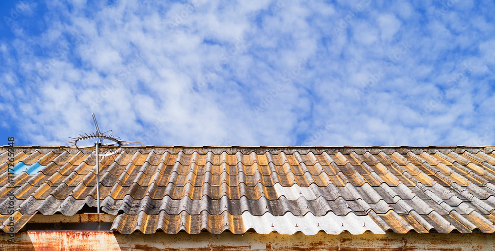 skys cloudy, and a tile roof skys cloudy, and a tile roof