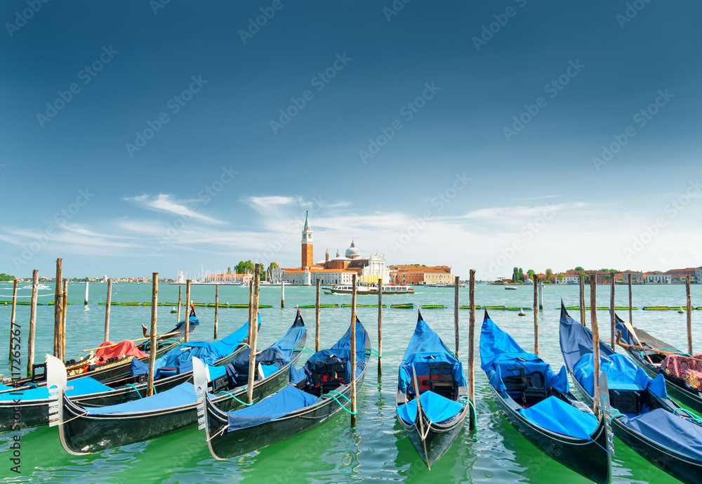 A row of gondolas parked beside the Riva degli Schiavoni, Venice