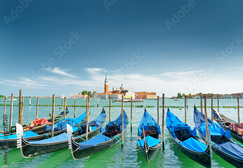 A row of gondolas parked beside the Riva degli Schiavoni, Venice