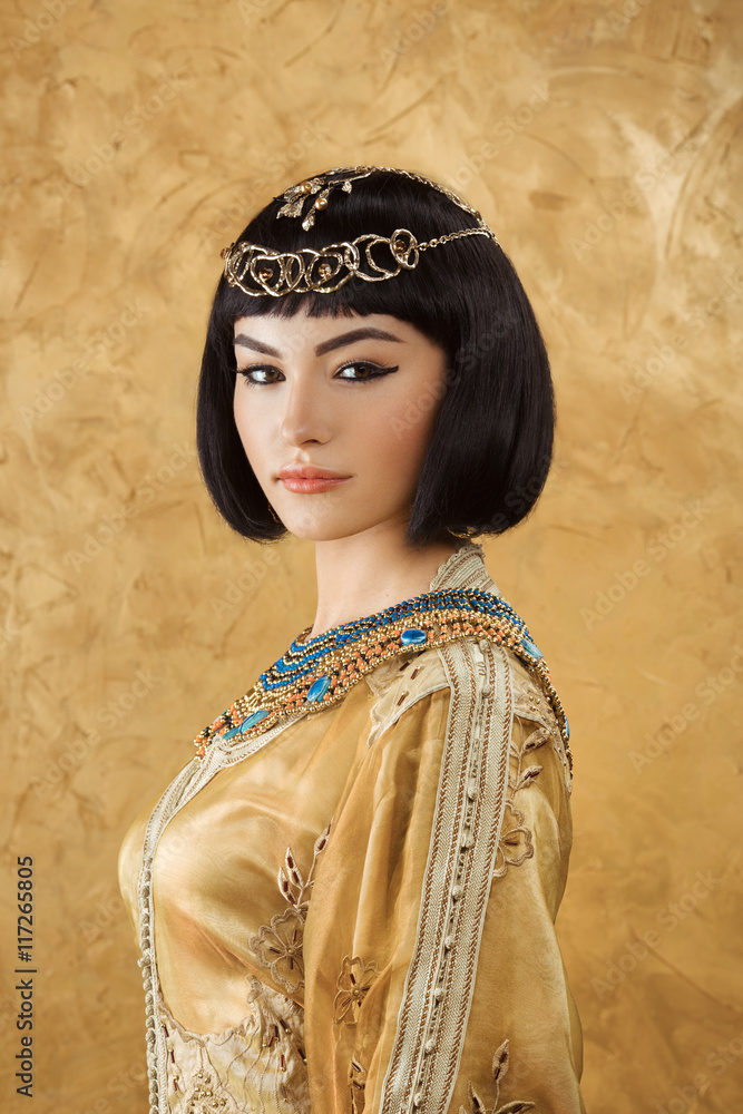 Beautiful woman like Egyptian Queen Cleopatra with serius face on ...