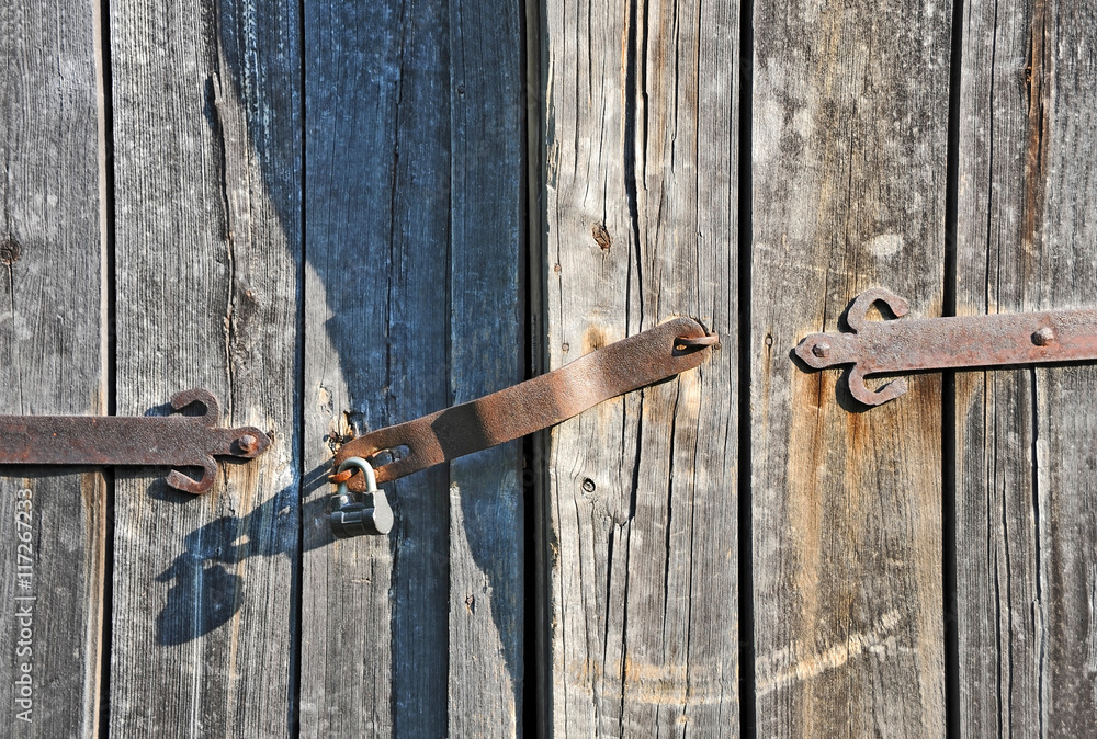 Rusty lock on old wooden gate Rusty lock on old wooden gate